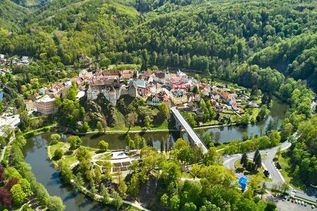 Panoramic view of Loket castle, surrounded by river Ohri and small houses on a river shore, Czech Republic.の写真素材