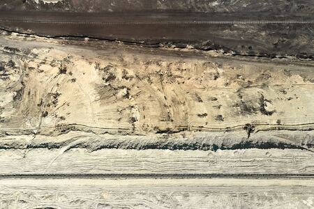Aerial view of coal mining with bucket wheel excavator. Top view of a quarry. Heavy mining industry