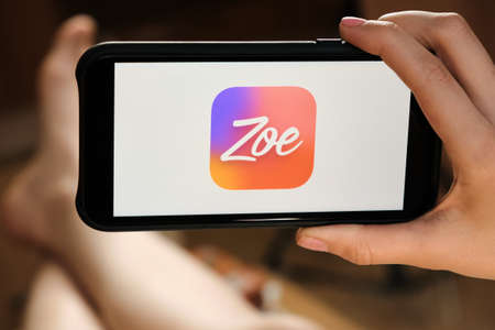 Zoe dating service using on the smartphone by LGBT lesbian girl for fall in love and communication. An illustrative editorial image. San Francisco, US, June 2020.のeditorial素材