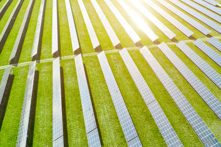 Aerial view of solar power station. Photovoltaic panels field for production of renewable energy....
