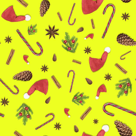 3D illustration of christmas seamless yellow background with red Santa Clause hats, Christmas tree fir branches, anise star, cinnamon stick, candy cane and cone. A wrap paper concept for new year presents. Xmas pattern for fabric, surface design or wall paper with copy space,の写真素材
