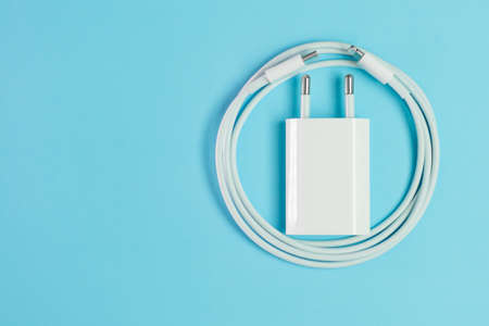 A white smart phone charger cable with lightning hi speed USB A connector and adapter.