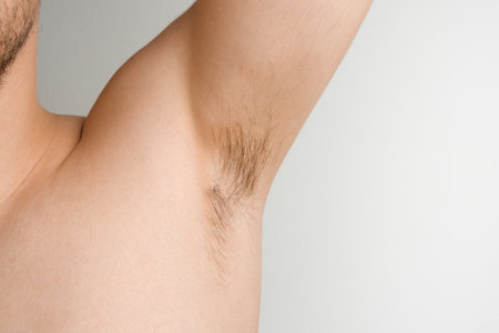Close up mans armpit with long hair on white backgroundの写真素材