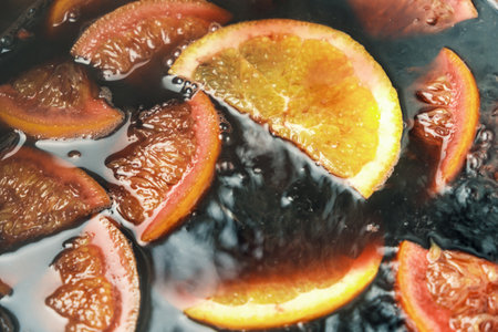 Making of mulled wine or punch with slices of orange, anise slice, cinnamon and clove.の写真素材