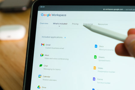 Google Workspace logo shown by apple pencil on the iPad Pro tablet screen. Man using application on the tablet. December 2020, San Francisco, USA.のeditorial素材