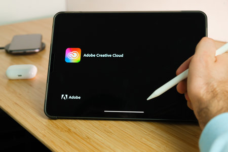 Adobe Creative Cloud is used with apple pencil on iPad Pro tablet . Man using application on the tablet. December 2020, San Francisco, USA.のeditorial素材