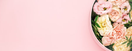 Luxury beautiful flowers in a hat round box on the pink background with copy space. Gift or present on St. Valentines Day, 8 March, Mother Day, weddingの写真素材