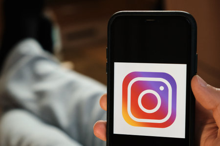 Instagram application on the smartphone in mans hand. Man laying and using application for dating and meeting. Social network concept, July 2020, Prague, Czech Republic.のeditorial素材