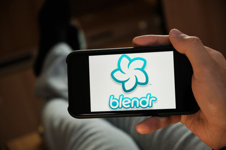 Blendr application on the smartphone in mans hand. Man laying and using application for dating and meeting. Social network concept, July 2020, Prague, Czech Republic.のeditorial素材