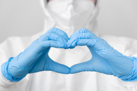 Doctor in a biohazard protective PPE suit and protective face mask against coronavirus, Sars-Cov-2,...