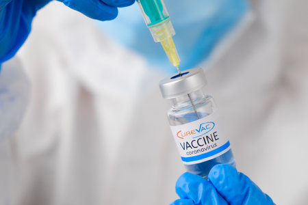 CureVac coronavirus Vaccine and syringe in the bottle or vial for injection in doctors hands. Covid-19, SARS-Cov-2 prevention, January 2021, San Francisco, USA.のeditorial素材