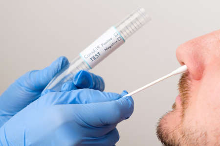 virus test. Medical worker or nurse taking a nasal swab for  virus sample from patient