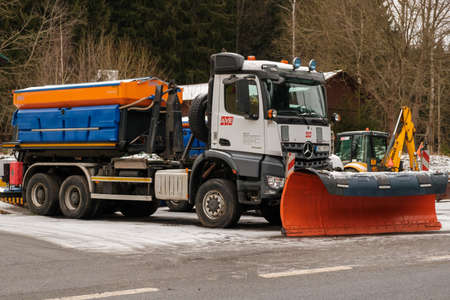 Winter service tractor or snow blower cleaning the road from snow to prevent icing, January 2021, Liberec, Czech Republic.のeditorial素材