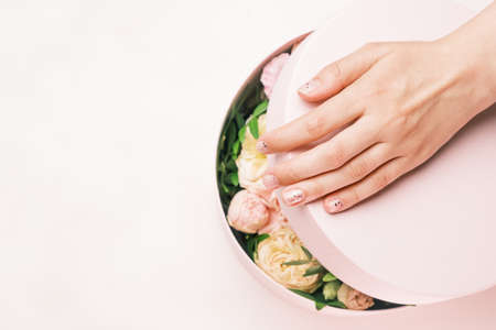 Close up womans hands opening gift boxes with fresh flowers. Spring is coming, international womens day, happy valentines day, 8 march, Mothers dayの写真素材