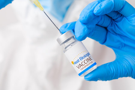 Heat Biologics vaccine against coronavirus collected into the syringe by health worker or doctor in protective gloves and PPE suit, April 2021, San Francisco, USAのeditorial素材