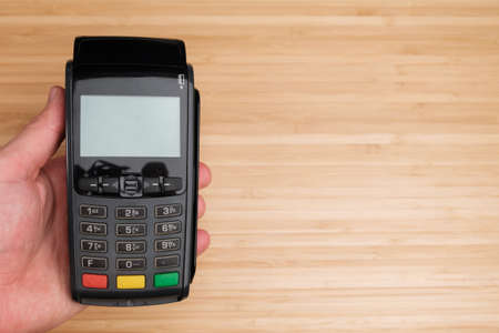 Man holding a terminal for contactless payment with copy spaceの写真素材
