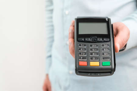 POS terminal or credit card reader machine on the white table with copy space.の写真素材