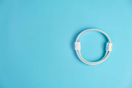 Cable with usb type C and lightening on the blue background with copy space.の写真素材