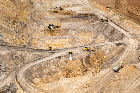 Aerial view of excavators digging ground. Opencast mining quarry.の写真素材