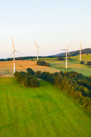 Aerial view of wind farm with high wind turbines for generation of eco electricity . Green power station.の写真素材