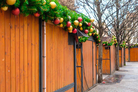 Christmas market stalls decorated with pine branch and colorful toy ballsの写真素材