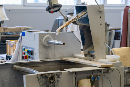 Vintage lathe machine with buttons on control panel installed in brightly lit empty workshop of production plant close viewの写真素材
