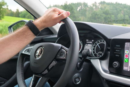 Close up man hand on the wheel of Skoda car while driving, September 2021, Poprad, Slovakia.のeditorial素材