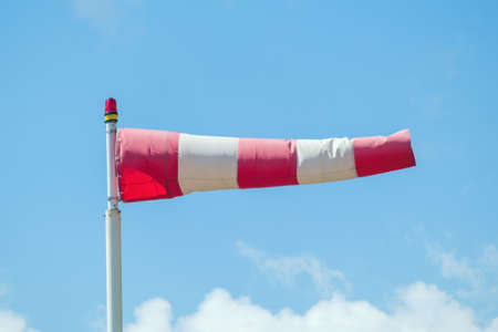 Windsock against a blue sky and clouds showed the wind direction.の写真素材