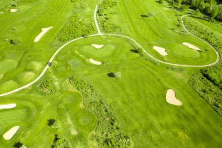 Golf course with sand bunker and green grass, aerial view.の写真素材