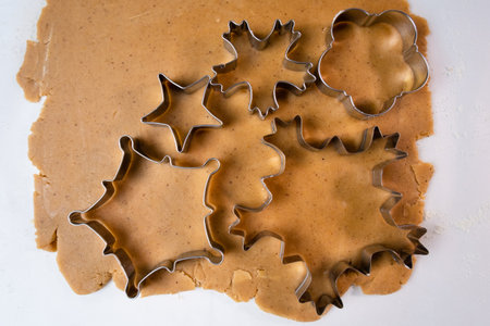 Cutting out cookies with metal mold from the shortcrust pastry. A metal forms in the form of...