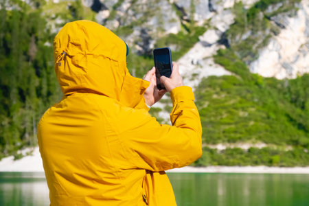 Travel blogger and tourist taking photo by smartphone of amazing landscape.の写真素材