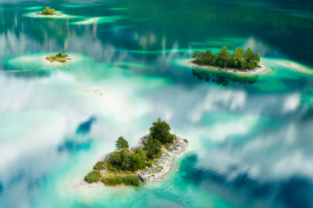 Unique islands with trees on a lake, turquoise water and clouds reflect, aerial view.の写真素材