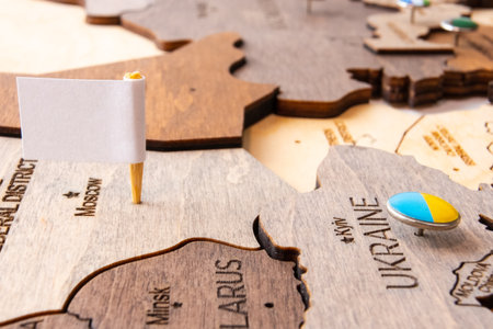 White flag on the wooden world map. Capitulation of Russia and Victory of Ukraine.の写真素材