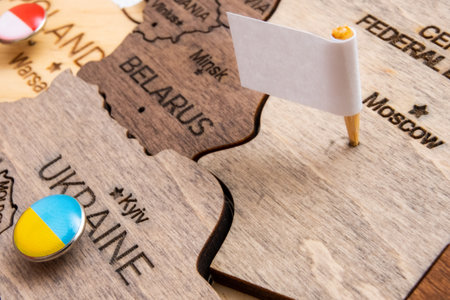 The capitulation of Russia in the war with Ukraine. Ukrainian victory. White flag in Moscow on the wooden map.の写真素材