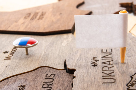 White flag in Kyiv on the wooden map. War of Russia and Ukraine.の写真素材