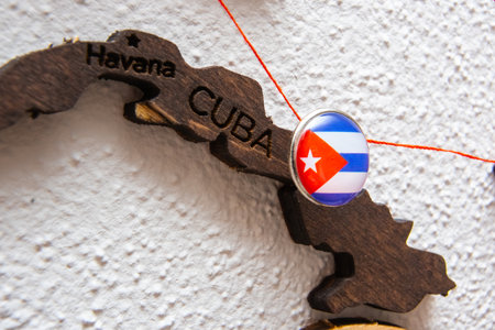Cuba flag on the pushpin with red thread showed the paths of movement or areas of influence in the global economy on the wooden map. Planning of traveling or logistic concept. Network connection.の写真素材