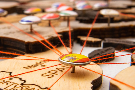 Spain flag pins and red thread for traveling and planning trips. Planning of logistics routes or spheres of influence in geopoliticsの写真素材