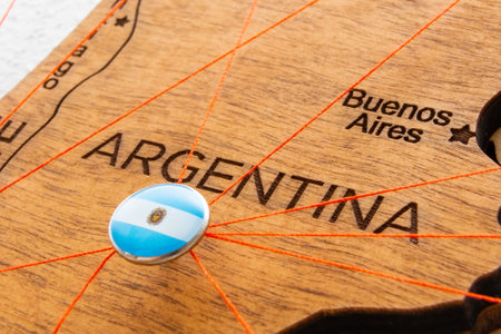 Argentina flag pins and red thread for traveling and planning trips. Planning of logistics routes or spheres of influence in geopoliticsの写真素材