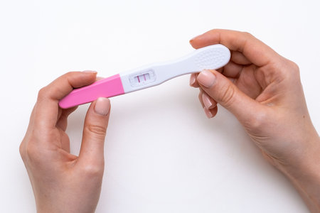 Pregnancy test in the woman hands on the white background.の写真素材