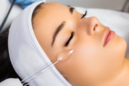 Hardware vacuum facial massage for skin smoothness. Woman enjoys procedure expecting quality...