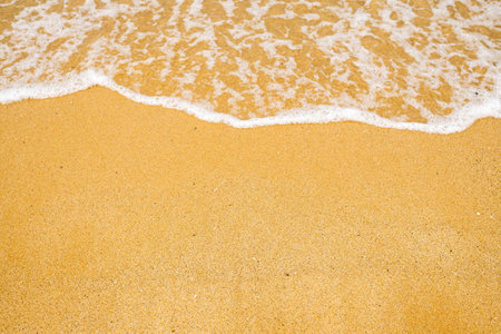 A stunning sandy beach with gentle waves lapping the shoreの写真素材