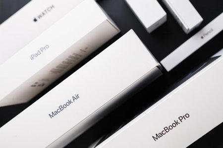BERLIN , GERMANY - FEBRUARY 14 2024: MacBook Pro, Air. iPad Pro and Apple watches on the black...