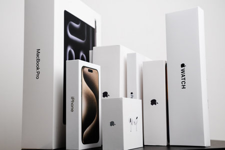 BERLIN , GERMANY - FEBRUARY 14 2024: MacBook Pro. iPhone, Air Pods Apple watch boxes standing on the table.のeditorial素材