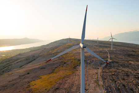 Modern wind turbines rotate generating clean energy on Pag Island. Innovative solution provides cost-effectiveness of wind energy in Croatiaの写真素材