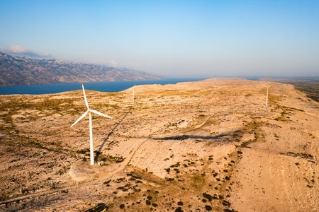 Wind turbines produce sustainable electric power on Pag Island. Innovative solution to obtain sustainable source of electricity without harm in Croatiaの写真素材