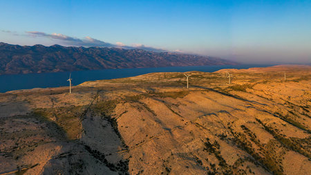 Aerial view of wind farm standing on the hill of island Pag surrounded by Adriatic sea, Croatia.