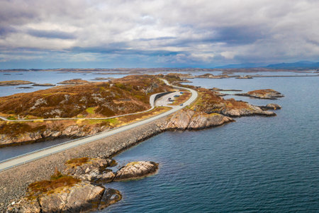 Breathtaking view of the Atlantic Ocean Road arching above the sea, connecting remote islands in Norways untamed coastal wilderness.の写真素材