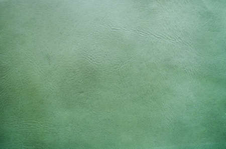A green natural leather background top view