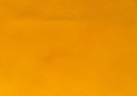 An orange natural leather background top view
