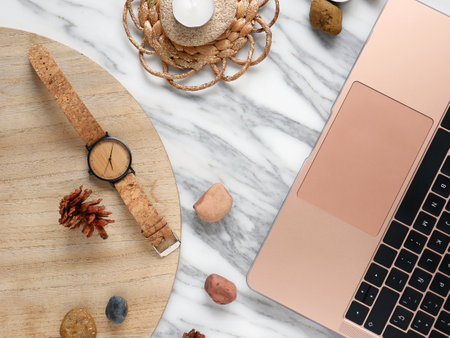 Work from home, desk creative office with laptop, marble, wallet and watchの写真素材